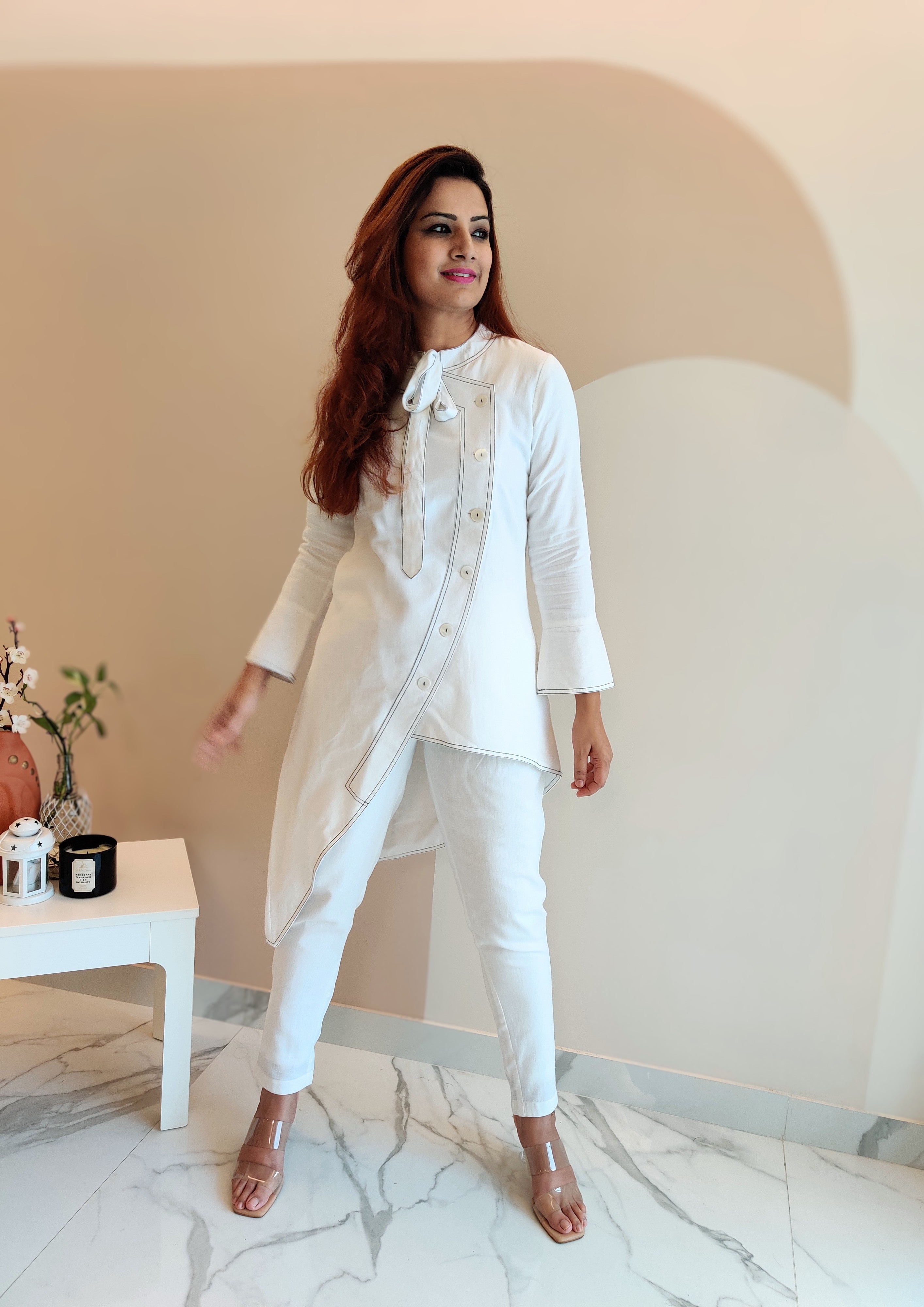 WHITE ASYMMETRIC LONG JACKET PAIRED WITH FITTED PANTS