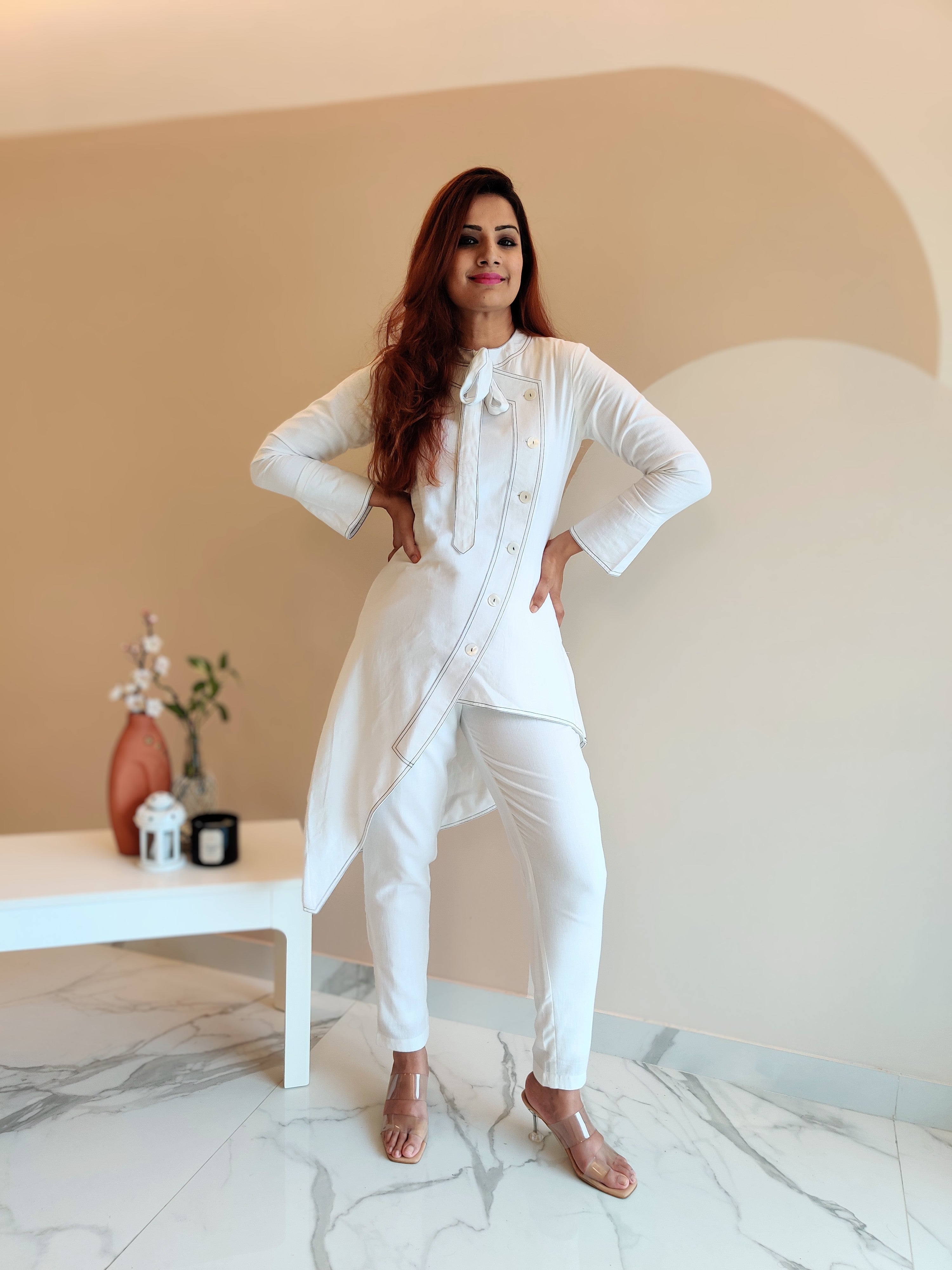 WHITE ASYMMETRIC LONG JACKET PAIRED WITH FITTED PANTS