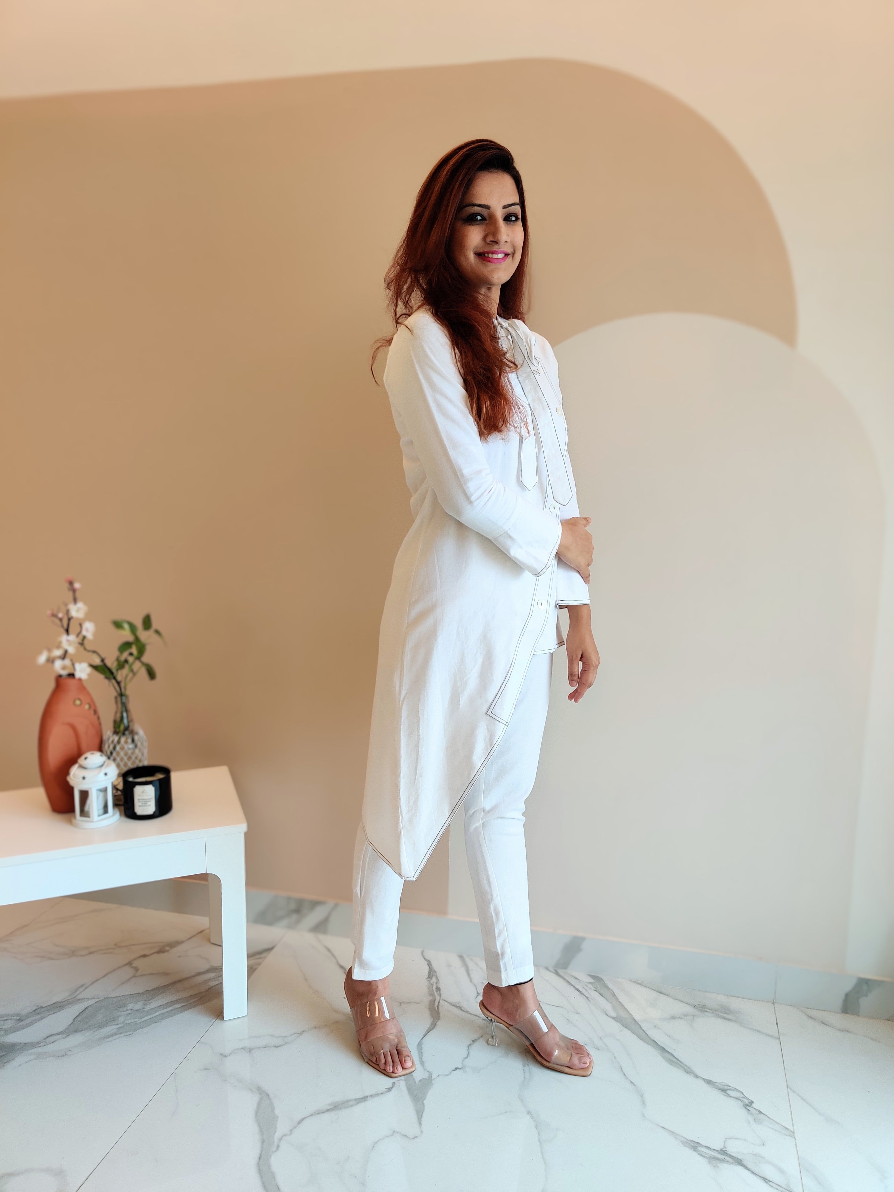 WHITE ASYMMETRIC LONG JACKET PAIRED WITH FITTED PANTS