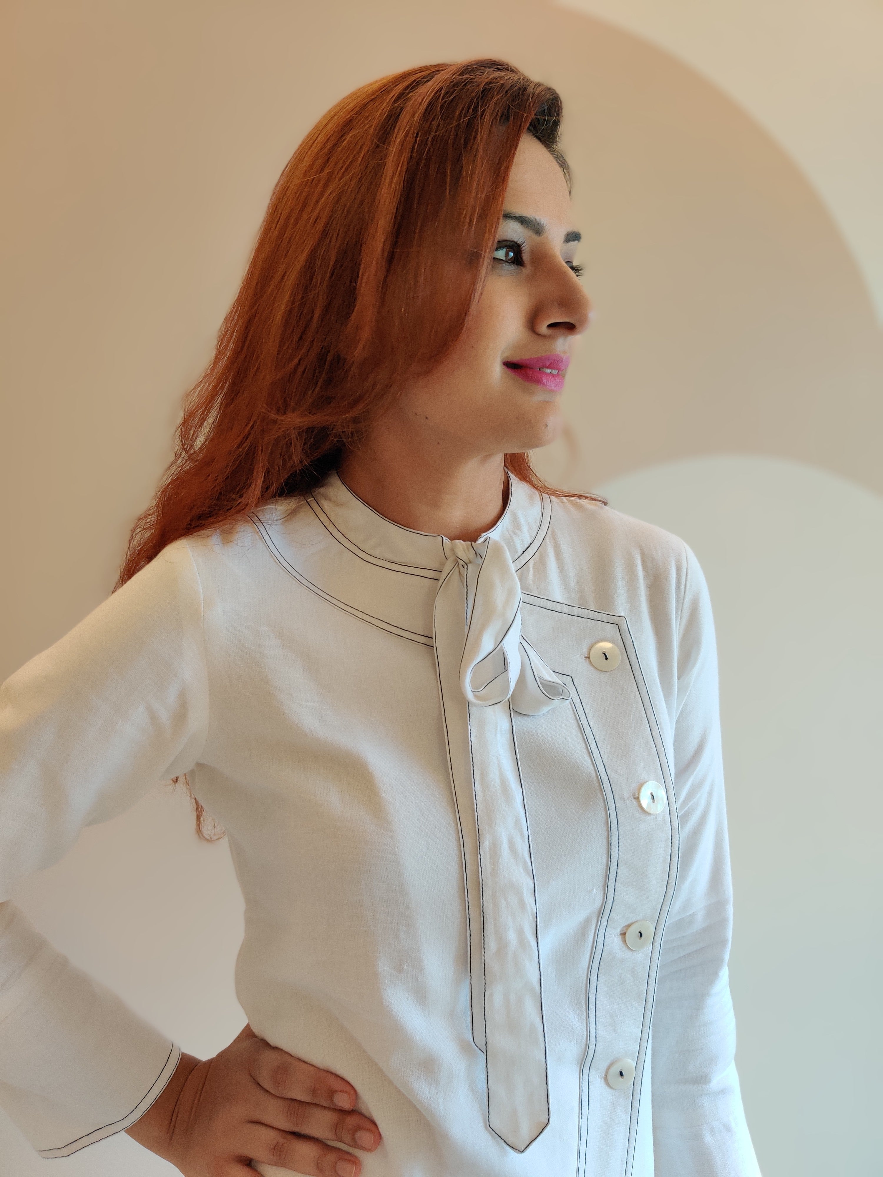 WHITE ASYMMETRIC LONG JACKET PAIRED WITH FITTED PANTS