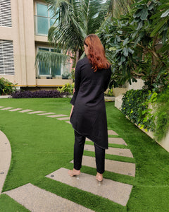 BLACK ASYMMETRIC LONG JACKET PAIRED WITH FITTED PANTS