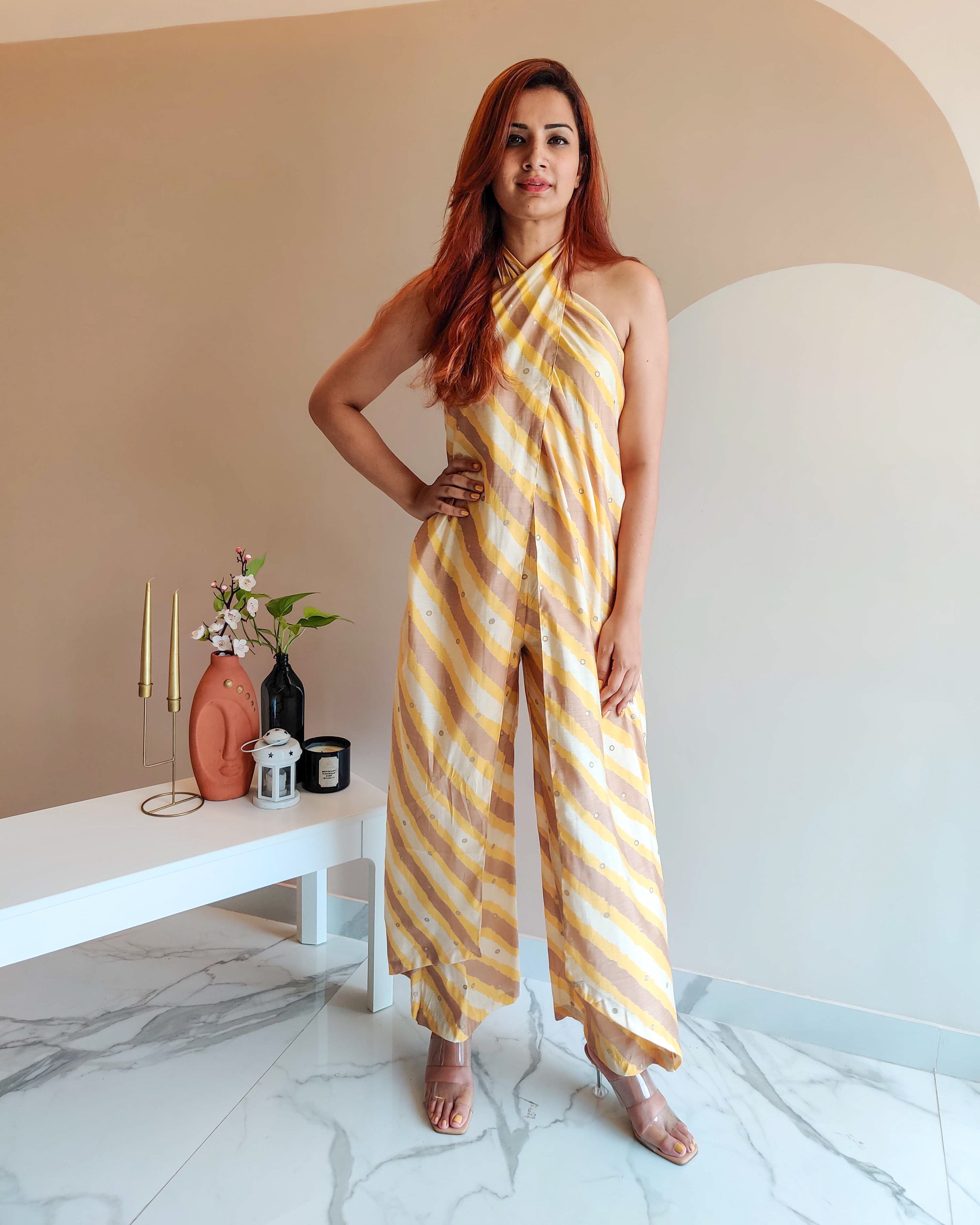 YELLOW PRINTED STRIPES HALTER NECK FLARED JUMPSUIT