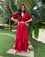 Load image into Gallery viewer, RED PUFFED SLEEVES TOP WITH TIE UP DETAIL PAIRED WITH FLARED PANTS
