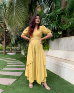 Load image into Gallery viewer, LIME YELLOW PUFFED SLEEVES TOP WITH TIE UP DETAIL PAIRED WITH FLARED PANTS
