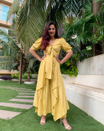 Load image into Gallery viewer, LIME YELLOW PUFFED SLEEVES TOP WITH TIE UP DETAIL PAIRED WITH FLARED PANTS
