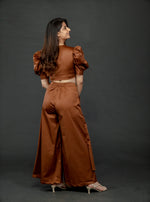 Load image into Gallery viewer, CHOCOLATE BROWN PUFFED SLEEVES TOP WITH TIE UP DETAIL PAIRED WITH FLARED PANTS
