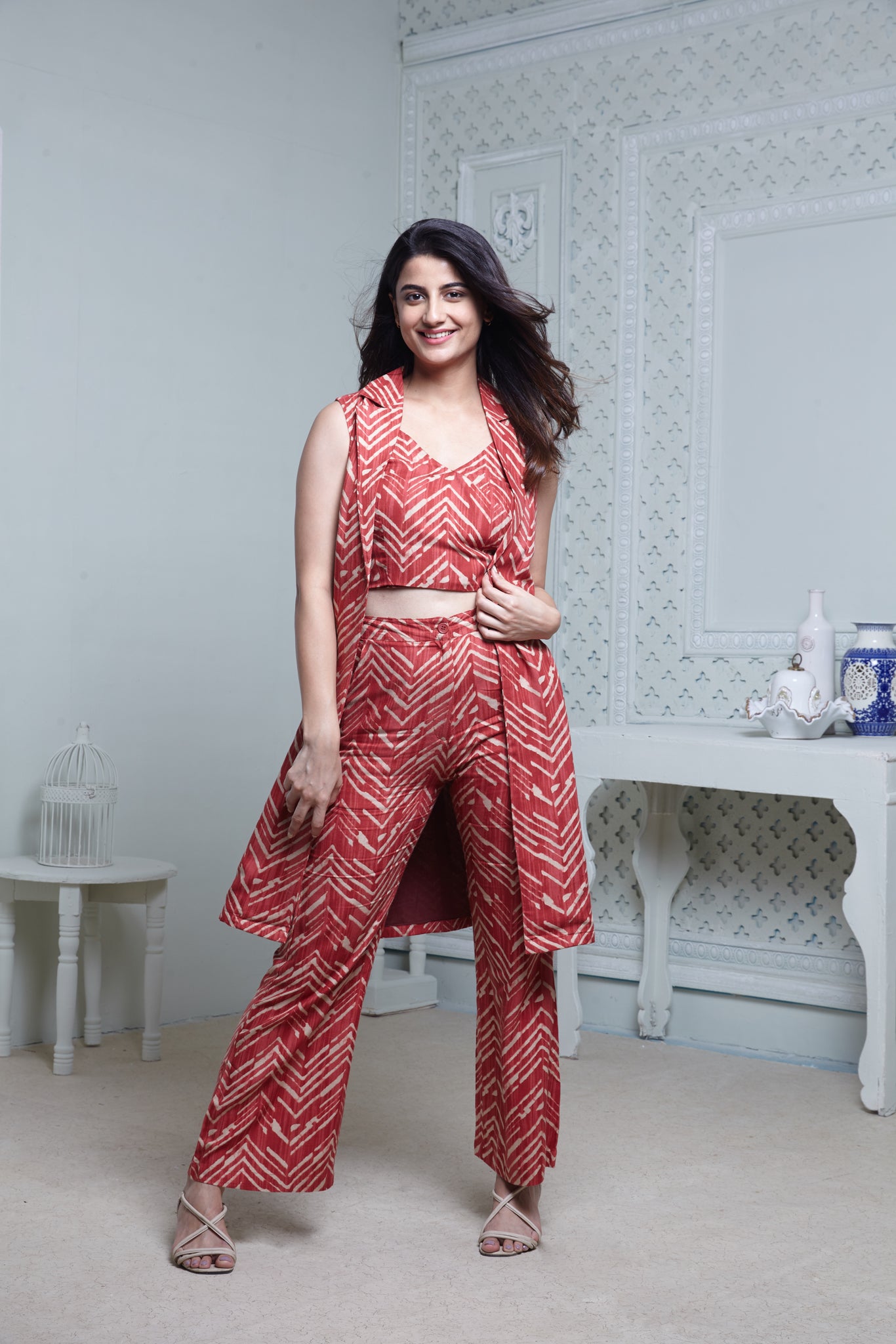 RED ZIGZAG SLEEVELESS LONG JACKET, HIPSTER PANT WITH BUSTIER