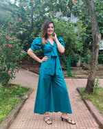 Load image into Gallery viewer, TEAL FRONT TIE UP AND PUFFED SHORT SLEEVED JUMPSUIT
