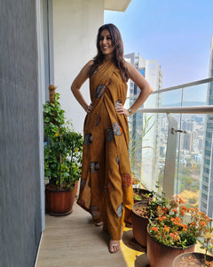 MUSTARD PRINTED HALTER NECK FLARED JUMPSUIT