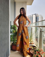 Load image into Gallery viewer, MUSTARD PRINTED HALTER NECK FLARED JUMPSUIT
