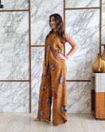 Load image into Gallery viewer, MUSTARD PRINTED HALTER NECK FLARED JUMPSUIT
