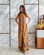 Load image into Gallery viewer, MUSTARD PRINTED HALTER NECK FLARED JUMPSUIT
